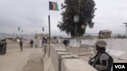 A worker paints circles for social distance at an entry gate of a school as preparation for reopening of educational institutions that were closed in March are finalized, in Lahore, Pakistan.