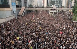 FILE - Protesters attend a demonstration demanding Hong Kong's leaders step down and withdraw the extradition bill, in Hong Kong, China, June 16, 2019.