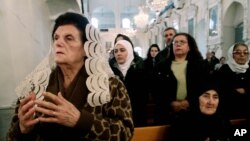 Syrian Christians and Muslims offer prayers for nuns held by rebels, at the Greek Orthodox Mariamiya Church in Damascus, Syria, Sunday, Dec. 8, 2013.