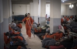 FILE - Suspected Islamic State fighters are detained in a prison in the northeastern Syrian city of Hasakeh, Oct. 26, 2019.