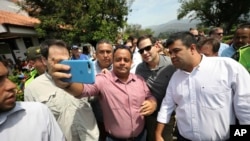 U.S. Senator Marco Rubio, R-Fla., in sunglasses, poses for photos with people near the Simon Bolivar International Bridge, which connects Colombia with Venezuela, in La Parada, near Cucuta, Colombia, Sunday, Feb. 17, 2019. 