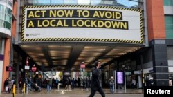 A sign calling on people to abide by government restrictions amid the spread of the coronavirus pandemic is seen in Manchester, Britain, Oct. 7, 2020. 