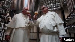 Father Karel Stautemas and Abbot Erik taste beer after blessing beer tanks at the Belgian Abbey of Grimbergen, which returns to brewing after a break of more than 200 years with a new microbrewery in Grimbergen, Belgium May 26, 2021. (REUTERS/Yves Herman)