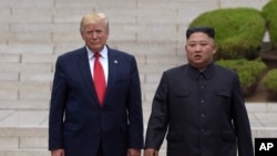 President Donald Trump, left, meets with North Korean leader Kim Jong Un at the North Korean side of the border at the village of Panmunjom in Demilitarized Zone, Sunday, June 30, 2019. (AP Photo/Susan Walsh)