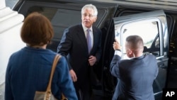 U.S. Defense Secretary Chuck Hagel (C) departs the U.S. Capitol after testifying at a closed Senate Armed Services hearing, July 8, 2014. 