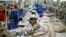 FILE - North Korean workers assemble jackets at a factory of a South Korean-owned company at the jointly run Kaesong Industrial Complex in Kaesong, North Korea, Dec. 19, 2013.