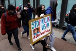 A protester navigates along Chicago's Loop during a peaceful protest, April 14, 2021, ahead of the video release of the fatal police shooting of 13-year-old Adam Toledo.