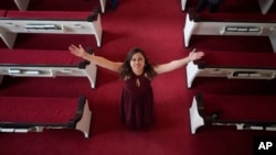Vicky Chavez poses for a photograph at the First Unitarian Church Thursday, April 15, 2021, in Salt Lake City. Chavez, a Honduran woman in the U.S. illegally who received sanctuary in a Salt Lake City church with her two young daughters for more than three years is now free to leave without risk of deportation. (AP Photo/Rick Bowmer).