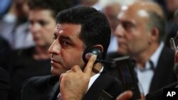 Pro-Kurdish People's Democratic Party leader Selahattin Demirtas listens to Greek Prime Minister Alexis Tsipras' speech to his party congress in Athens, Oct. 13, 2016.