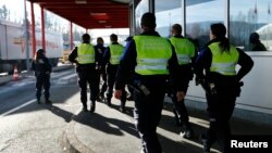 Swiss customs officers arrive at the Swiss-French customs post of Bardonnex near Geneva, Switzerland, Dec. 11, 2015. 