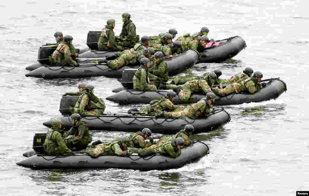 Japan Self-Defense Force (JSDF) soldiers ride rubber boats near Eniyabanare Island during a military drill, off Setouchi town on the southern Japanese island of Amami Oshima, Kagoshima prefecture, in this photo taken by Kyodo.