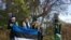 Team Estonia, which participated in the EU representatives' tree-planting effort in Washington, was led by Ambassador Jonatan Vseviov, second from left, and featured Johannas, age 2½, son of Ranner Selge, IT specialist at the embassy. (Natalie Liu/VOA) 