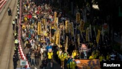 Thousands of pro-democracy protesters march in the streets to demand universal suffrage and urge Hong Kong's Chief Executive Leung Chun-ying to step down in Hong Kong, Jan. 1, 2014. 