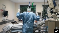 An intubated COVID-19 patient gets treatment at the intensive care unit at the Westerstede Clinical Center, a military-civilian hospital in Westerstede, northwest Germany, Dec. 17, 2021. 