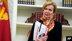 Empty chairs lines a sidewalk outside a restaurant Washington's Georgetown district, April 29, 2020.