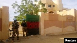 FILE - MINUSMA peacekeepers stand guard in front of the governor's office in Kidal, Mali.