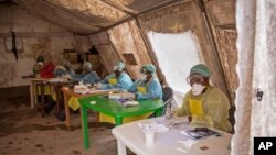 Health workers await patients to screen for the deadly Ebola virus at the Kenema Government Hospital in Sierra Leone.