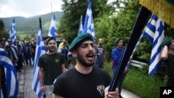 FILE - In this June 17, 2018 file photo, opponents of the deal between Greece and Macedonia on the latter country's new name - North Macedonia - hold Greek flags as they protest in northern Greece. Greece has moved to expel two Russian diplomats over allegations that organizations allegedly received Russian money to protest the agreement.