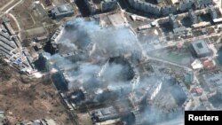 A satellite image shows burning apartment buildings in Mariupol