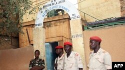 This photo taken on June 1, 2013 shows soldiers standing guard at the entrance of the main prison in Niamey. 