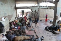 FILE - Survivors of Cyclone Idai wait in an abandoned and derelict building near Nhamatanda, about 50 kilometers from Beira, in Mozambique, March, 22, 2019.