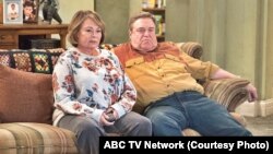 FILE - In this image released by ABC, Roseanne Barr and John Goodman appear in a scene from the reboot of "Roseanne."