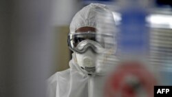 FILE - A technician tests swabs from patients for COVID-19 infection at the Central Health Laboratory in the Yemeni capital Sanaa, amid the novel coronavirus pandemic, April 11, 2020. 