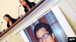 FILE - Zhang Qing, left, wife of Chinese human rights activist Guo Feixiong, and daughter Yang Tianjiao speak at a press conference before a hearing of a House Foreign Affairs Committee subcommittee in Washington, DC, Oct. 29, 2013.