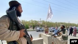 សមាជិកក្រុមសកម្មប្រយុទ្ធតាលីបង់យាមល្បាតច្រកចូលក្រសួងមហាផ្ទៃ ក្នុងរដ្ឋធានីកាប៊ុល ប្រទេសអាហ្វហ្គានីស្ថាន កាលពីថ្ងៃទី ១៧ ខែសីហា ឆ្នាំ ២០២១។