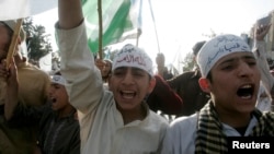 FILE - Activists of the Islamic alliance Muttahida Majlis-e-Amal chant anti-government slogans during a protest against emergency rule in Islamabad, Nov. 16, 2007. There was a split in MMA because of differences among different political parties, and it collapsed in 2008. But in December 2017, the religious heads of five Islamist parties announced the revival of MMA to contest the 2018 general elections.