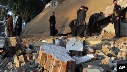 Violence continues to erupt in the Pakistani border region of Mohmand. Pakistani officials search among the rubble of a destroyed building following a suicide attack on an administrative compound in Ghalanai, Dec. 6, 2010.