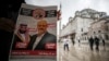 A man holds a poster showing images of Saudi Crown Prince Muhammed bin Salman (L), dubbed "assassin," and of journalist writer Jamal Khashoggi, dubbed "martyr," during a prayer service for Khashoggi, in Istanbul, Turkey, Nov. 16, 2018.
