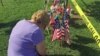 A woman pays her respects at an impromptu memorial near the scene of a shooting for the four U.S. Marines gunned down at an Armed Forces Career Center/National Guard recruitment office in Chattanooga, Tennessee, July 17, 2015. (VOA / S. Behn)