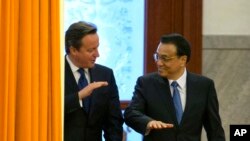 British Prime Minister David Cameron, left, chats with Chinese Premier Li Keqiang as they arrive for a welcome ceremony at the Great Hall of the People in Beijing, China, Monday, Dec. 2, 2013.
