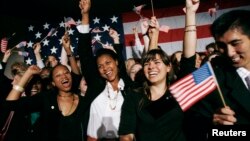 A tourist reads the inscriptions carved on the walls of the Jefferson Memorial as the early morning sun flares through the columns during the Presidents Day holiday in Washington, D.C.
