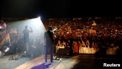 Hamed Sinno (L), the lead singer of Lebanese alternative rock band Mashrou' Leila performs during the Ehdeniyat International Festival in Ehden town, Lebanon, Aug. 12, 2017. 
