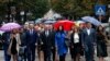 Belgrade-backed Srpska Lista leader Goran Rakic, center left, with supporters arrives at a polling station in northern Serb-dominated part of ethnically divided town of Mitrovica, Kosovo, Oct. 6, 2019.