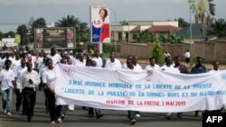 Burundian journalists carry a banner as they march in the streets of Burundi's capital Bujumbura, May 3, 2011. 