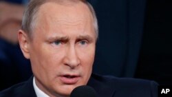 FILE - Russian President Vladimir Putin explains the Brexit vote result by saying that "people are dissatisfied with the decision of the security issues that have sharply deteriorated in the face of strong migration processes. People want to be more independent."