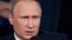 FILE - Russian President Vladimir Putin explains the Brexit vote result by saying that "people are dissatisfied with the decision of the security issues that have sharply deteriorated in the face of strong migration processes. People want to be more independent."