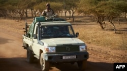 FILE - A vehicle of the Burkina Faso Army patrols a rural area in the Soum region in northern Burkina Faso, Nov. 14, 2019. At least 32 military police were killed in an attack on a military outpost in the area.