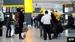 Travellers wearing a face mask or covering due to the COVID-19 pandemic
