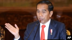 Indonesia President Joko Widodo gestures as he speaks during a press conference at the palace in Jakarta, Indonesia, Monday, Aug. 26, 2019. Indonesia's president has announced to relocate the country's capital.