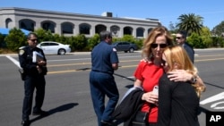 美国加州波威市的恰巴德犹太教堂发生枪击后，教堂外面，人们拥抱。