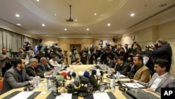The Houthi rebel delegation, right, and delegates of the internationally recognized Yemeni government hold talks on a stalled prisoner exchange, in Amman, Jordan, Feb. 5, 2019.