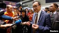 Cambodia's self-exiled opposition party founder Sam Rainsy, who has vowed to return to his home country, talks to supporters after being prevented from checking-in for a flight from Paris to Bangkok at Roissy Airport in Paris, France November 7, 2019