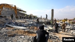 FILE - A man sits amidst the rubble at a site damaged in the aftermath of an Israeli strike on the town of Al-Ain in the Baalbek region, amid the ongoing hostilities between Hezbollah and Israeli forces, in Lebanon, Nov. 6, 2024.