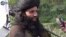 FILE - This undated image provided the SITE Intel Group, an American private terrorist threat analysis company, shows Mullah Fazlullah in Pakistan. 