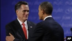 Republican presidential nominee Mitt Romney (L) shakes hands with President Barack Obama following the first presidential debate at the University of Denver, October 3, 2012, in Denver.