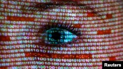 FILE - An illustration picture shows a projection of text on a woman's face in Berlin, Germany, June 12, 2013. The EU demanded an explanation from the US attorney general following evelations of massive U.S. collection of foreign data.